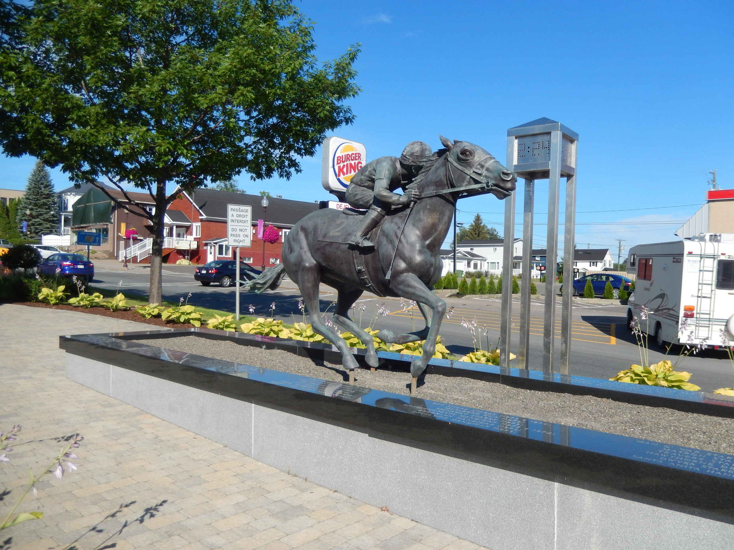 A statue of the race horse Secretariat and his jockey, Ron Turcotte, stands proudly across the street from a Burger King.