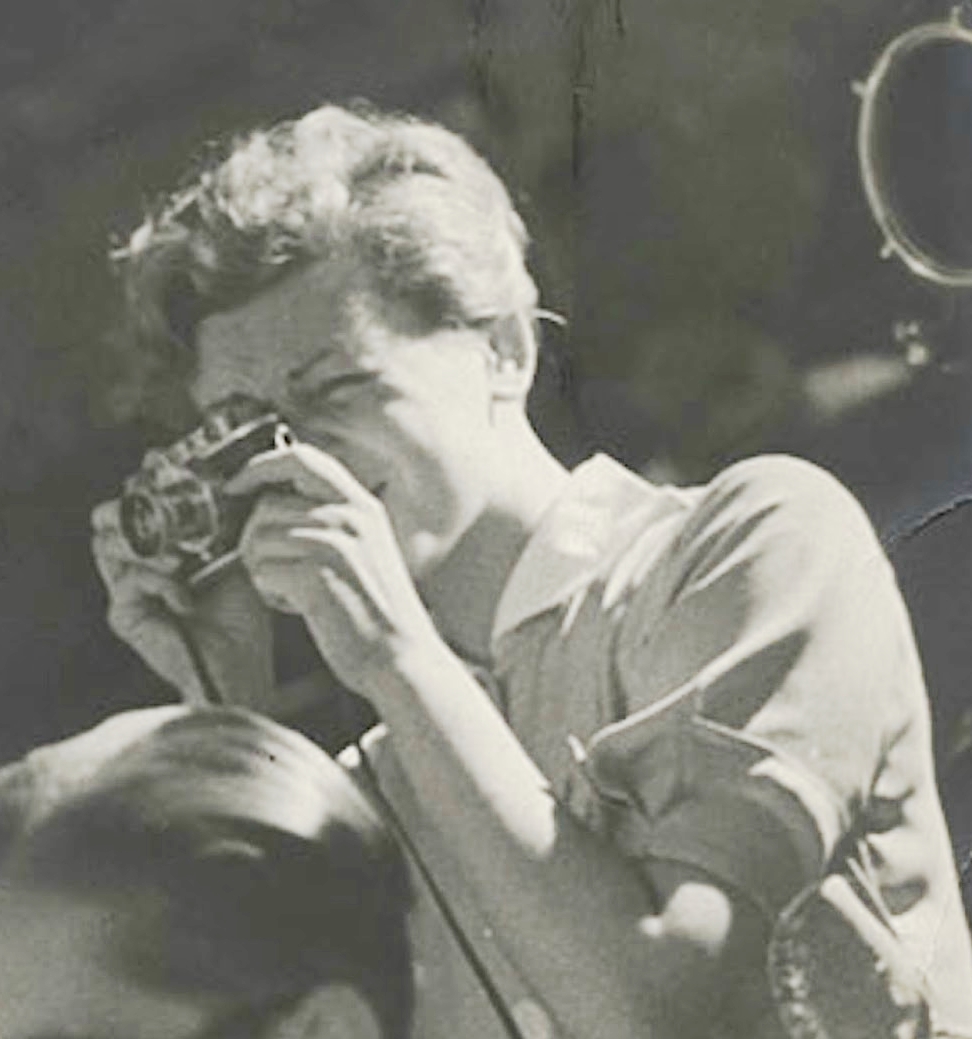 In a black-and-white photo from 1937, hotojournalist Gerda Taro takes a photograph during the Spanish Civil War.