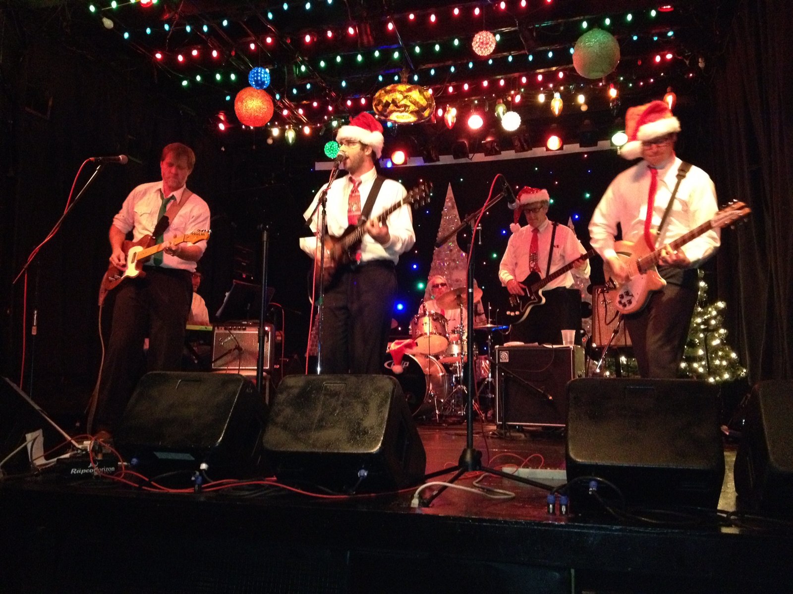 The four-man rock band Buzz Killingtons performs in Santa hats like a bunch of dorks.
