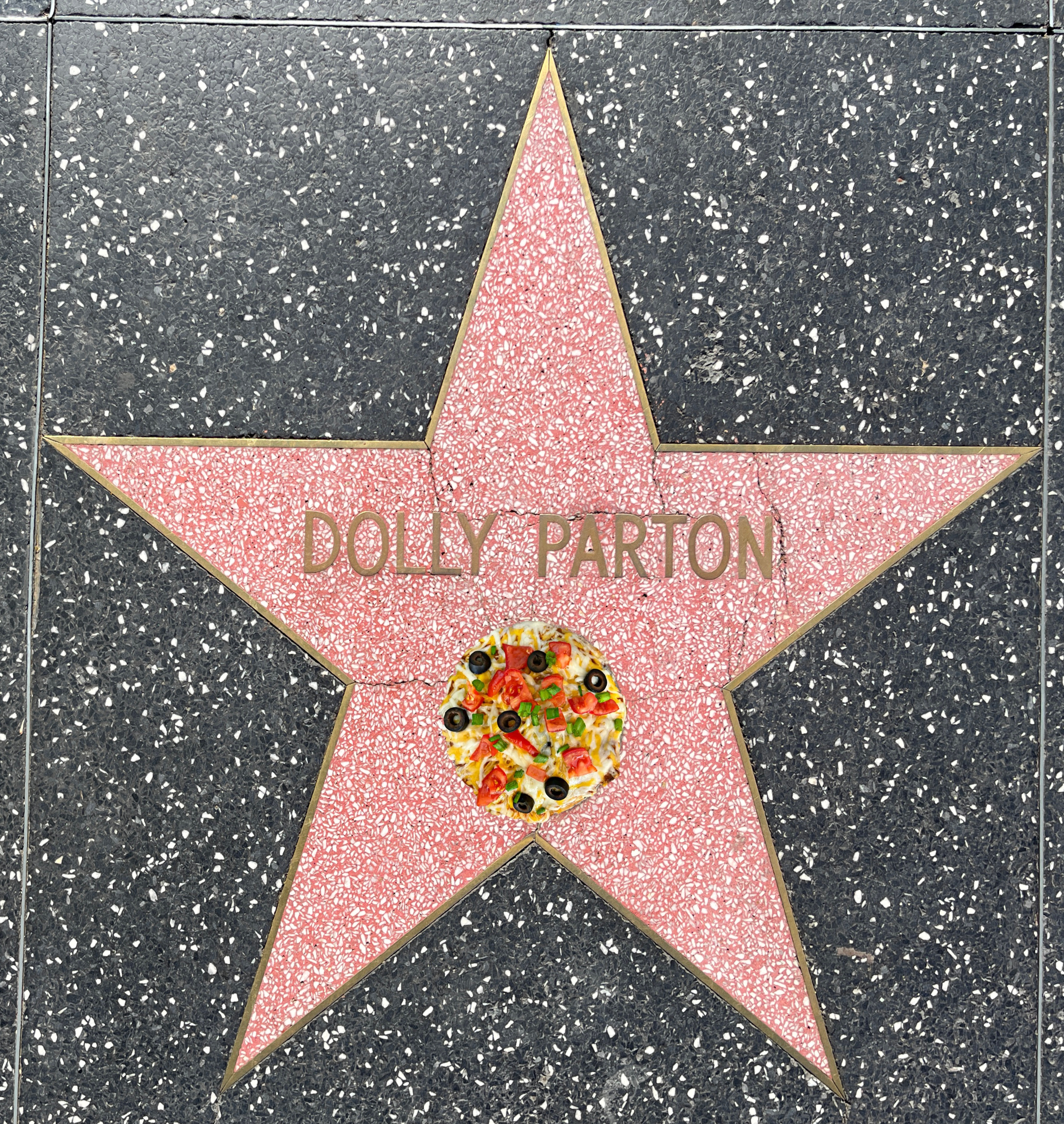 Dolly Parton's star on the Hollywood Walk of Fame with a Mexican Pizza on top