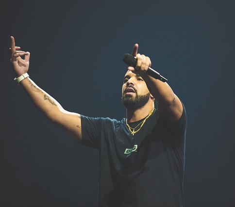 Singer Drake gesturing to crowd.