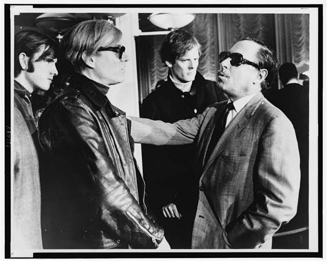 Andy Warhol and Tennessee Williams talk on the deck of a cruise ship in 1967